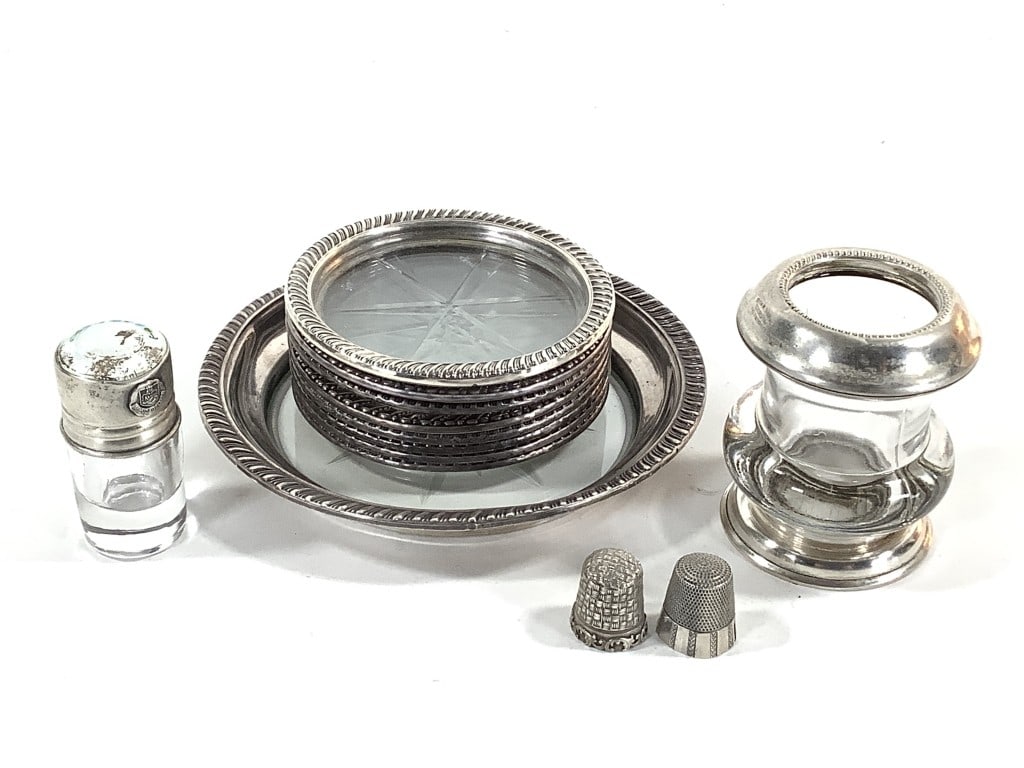 Sterling Coasters Toothpick Holder Thimbles +: Eight 3 5/8" Dia. sterling coasters with a cut glass bottom, marked 'Sterling'. 5 5/8" Dia. small plate with a cut glass bottom, marked 'Sterling'. 7/8"H thimble, marked 'Sterling'. 1"H thimble, marke