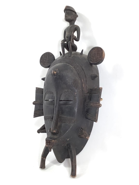Senufo W African Tribal Mask Finely Carved Wood: Fertility mask, community celebration, Senufo people - Mali, Benin, Ivory Coast. Male figure seated at top. 13 1/4"H. Note old repair on left support leg. EDS aims to describe and photograph all items
