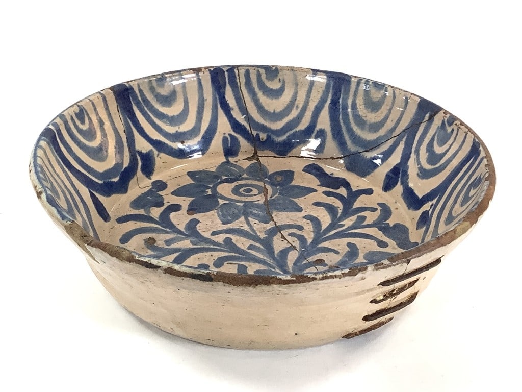 Antique Stoneware Bowl w Old Staple Repairs: 12 1/2" Dia., 3 1/2"H. Early blue glaze decorated stoneware bowl. Unmarked, with staple repairs along three break lines. EDS aims to describe and photograph all items thoroughly and accurately, howeve