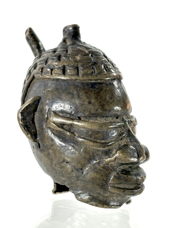 Benin Bronze Bust Miniature: 1 1/4"H bronze bust, made by the Benin people of Edo. Provenance: Collected by Sophia and Roy Sieber.