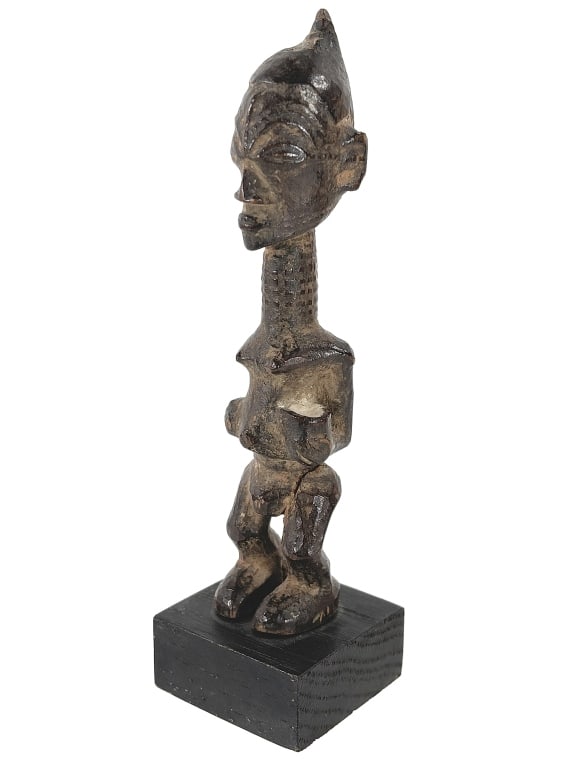 Standing Mbulenga Figure: Long-necked Lulua figures are used for a range of spiritual practices and are associated with ancestral spirits. Those supporting a vessel in one hand are called mbulenga, meaning ?for beauty, for