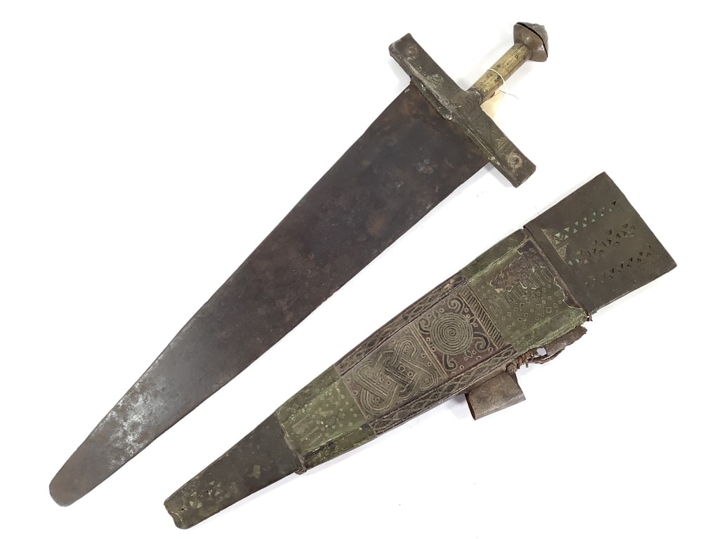 Senufo Sword W/ Brass And Leather Yawiige Sheath: 31"L x 9"W. Provenance: Collected by Sophia and Roy Sieber.