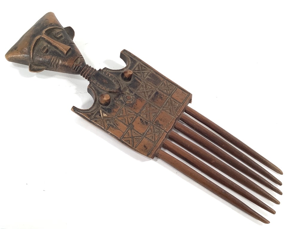 Akan Wood Comb From Ghana: 10"L x 3"W, missing a tooth. Provenance: Collected by Sophia and Roy Sieber.