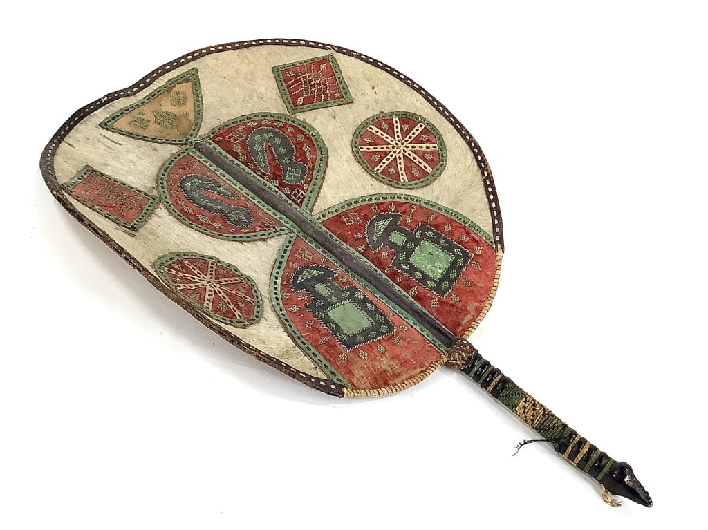 19th C Benin Hide Royal Fan: 14"Dia., 21"L. Provenance: Collected by Sophia and Roy Sieber.