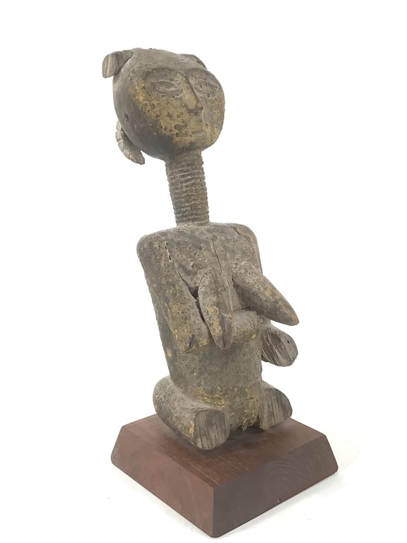 Asante Queen Mother Figurine From Ghana: 14"H, includes the stand. Visible repairs throughout, missing lower half and half the hair. Provenance: Collected by Sophia and Roy Sieber.