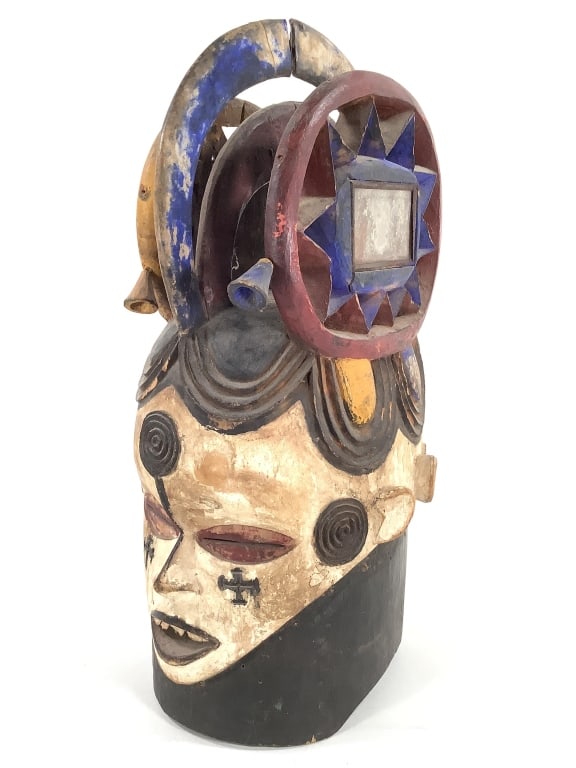 Igbo Painted Helmet Mask With Mirrors: 12"L x 20"H. Central crest is split. Provenance: Collected by Sophia and Roy Sieber.