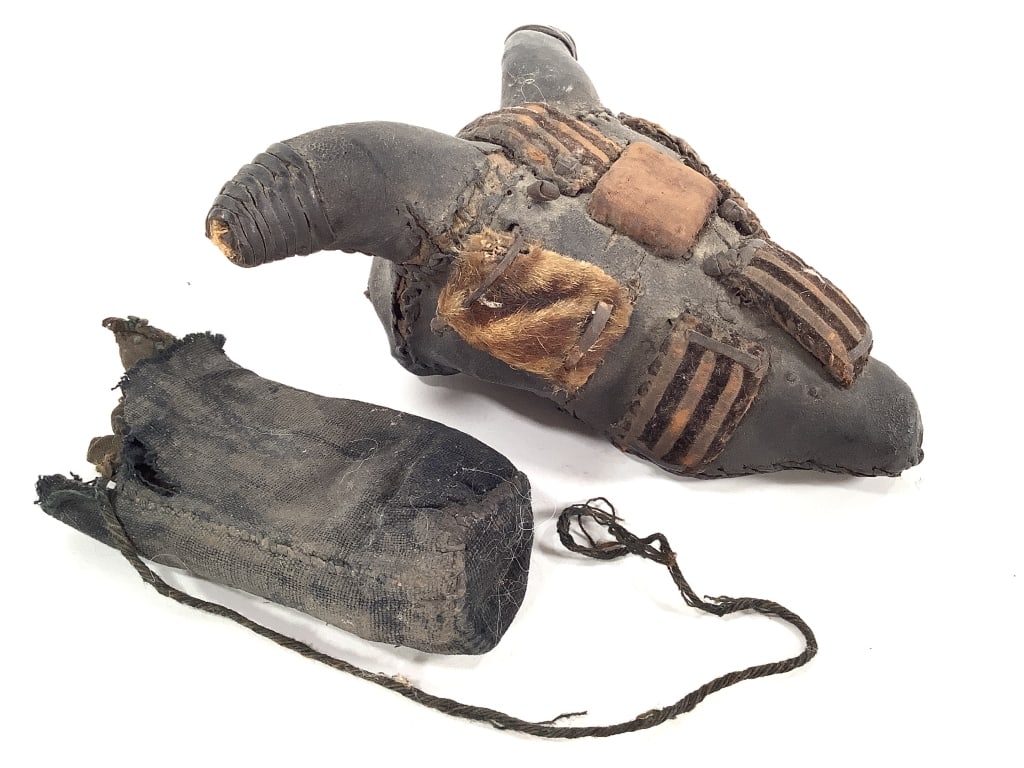 Nigerian Bull Head Figure With Pouch: 6 1/2"W x 7"L, leather and cloth squares. Provenance: Collected by Sophia and Roy Sieber.