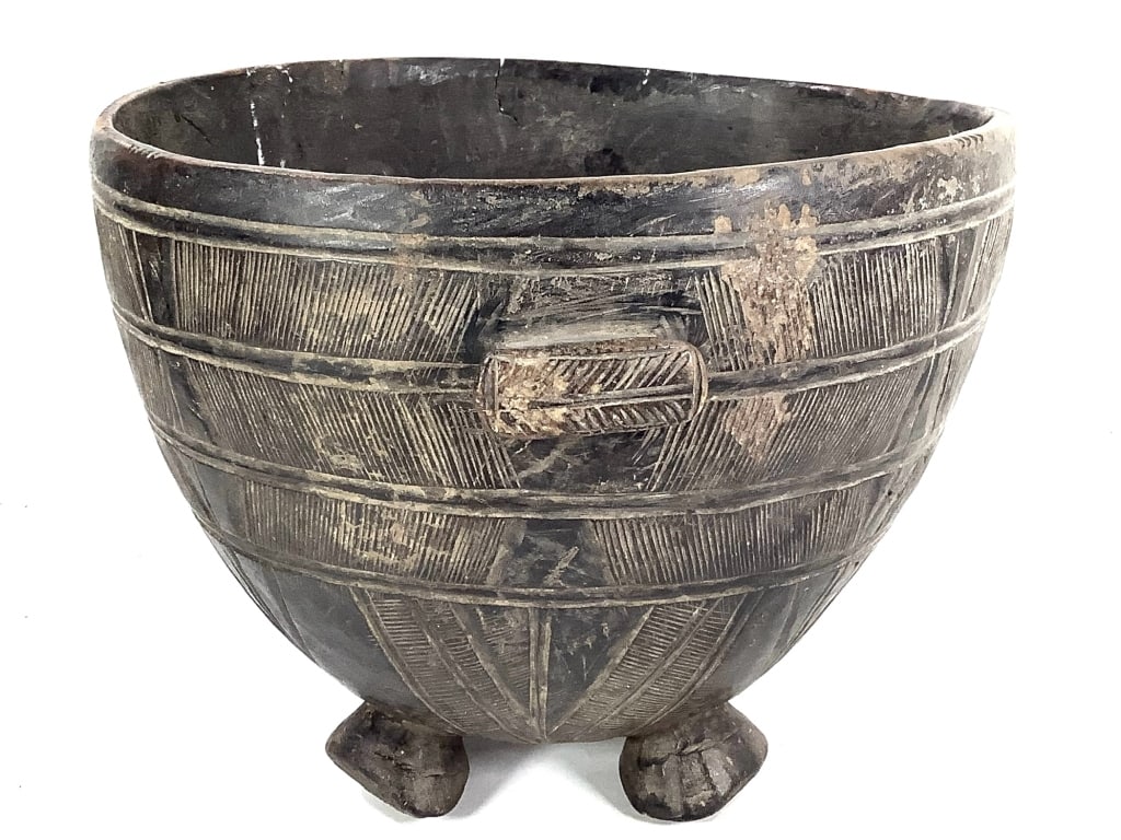 Carved Wood Footed Bowl Incised Designs: 12"DIa., 9 1/2"H. Provenance: Collected by Sophia and Roy Sieber.