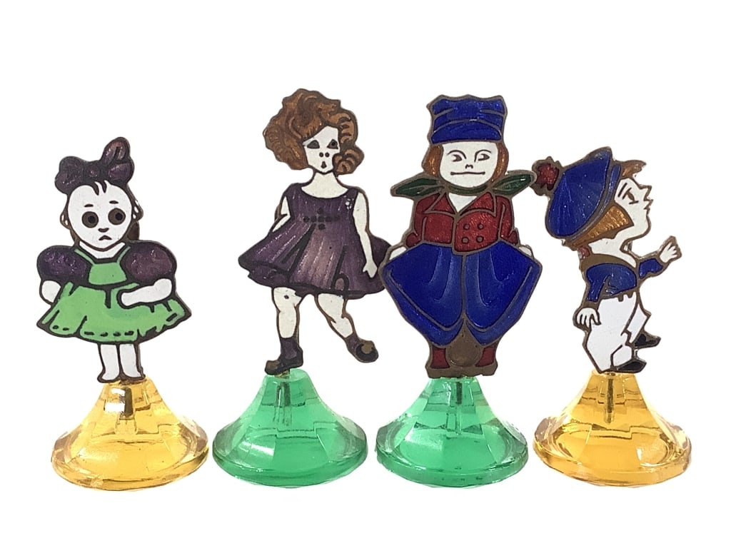 4 Enamel Metal Name Card Holders 1920-30s: 3/4"H overall, unusual etched and enameled copper figures with clip on back, mounted to colored glass prism bases. Each figure represents a different, unidentified cartoon like character - likely earl