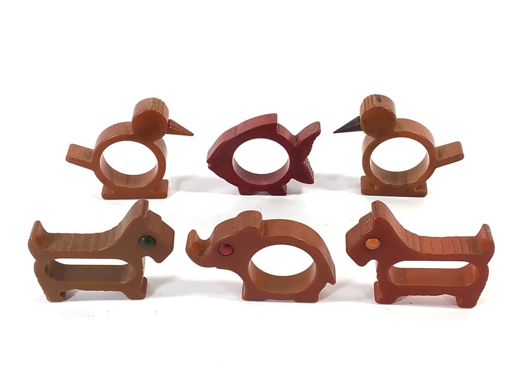 6 Bakelite Animal Shape Napkin Rings: Early bakelite napkin rings - 2 Scottie dogs, 2 birds, elephant and fish. 3 with inset eyes, birds with cone beaks. 2 3/4" - 3"L. Provenance: Collection of William and Diane Itter.