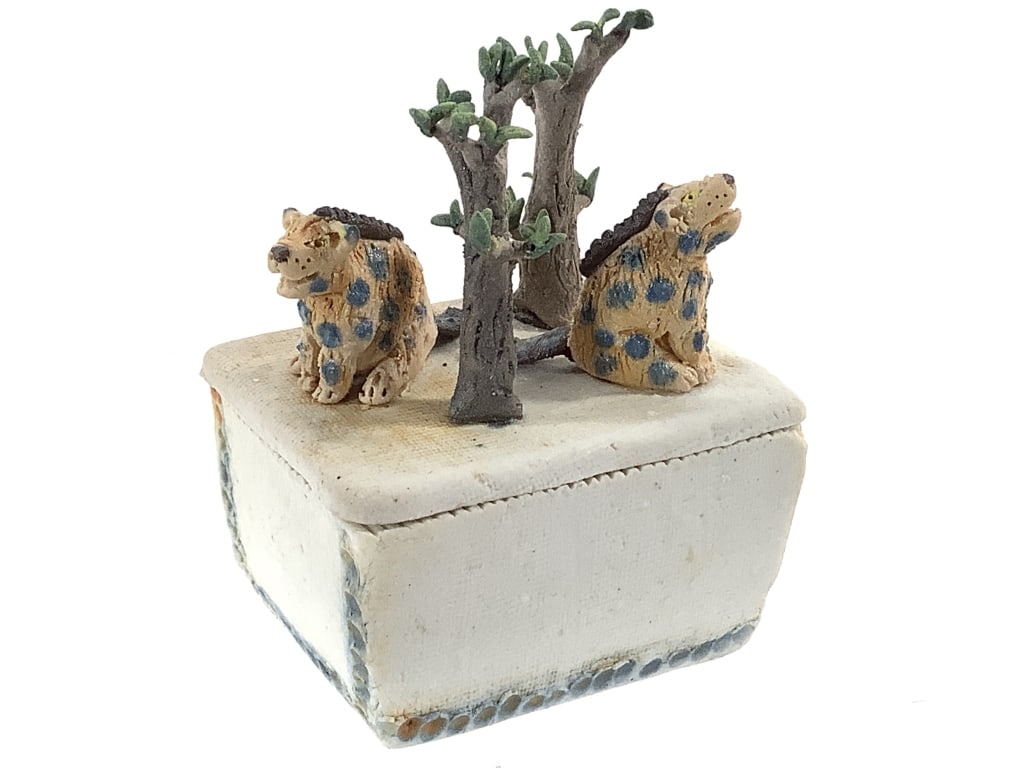 Miniature Artist Box w Hyenas & Trees: 2 1/4" x 1 3/4" x 3"H overall, box with lid supporting figural scene. Signed on bottom, illegible. Handmade and painted. Material appears to be ceramic and / or marble paste. Provenance: Collection of