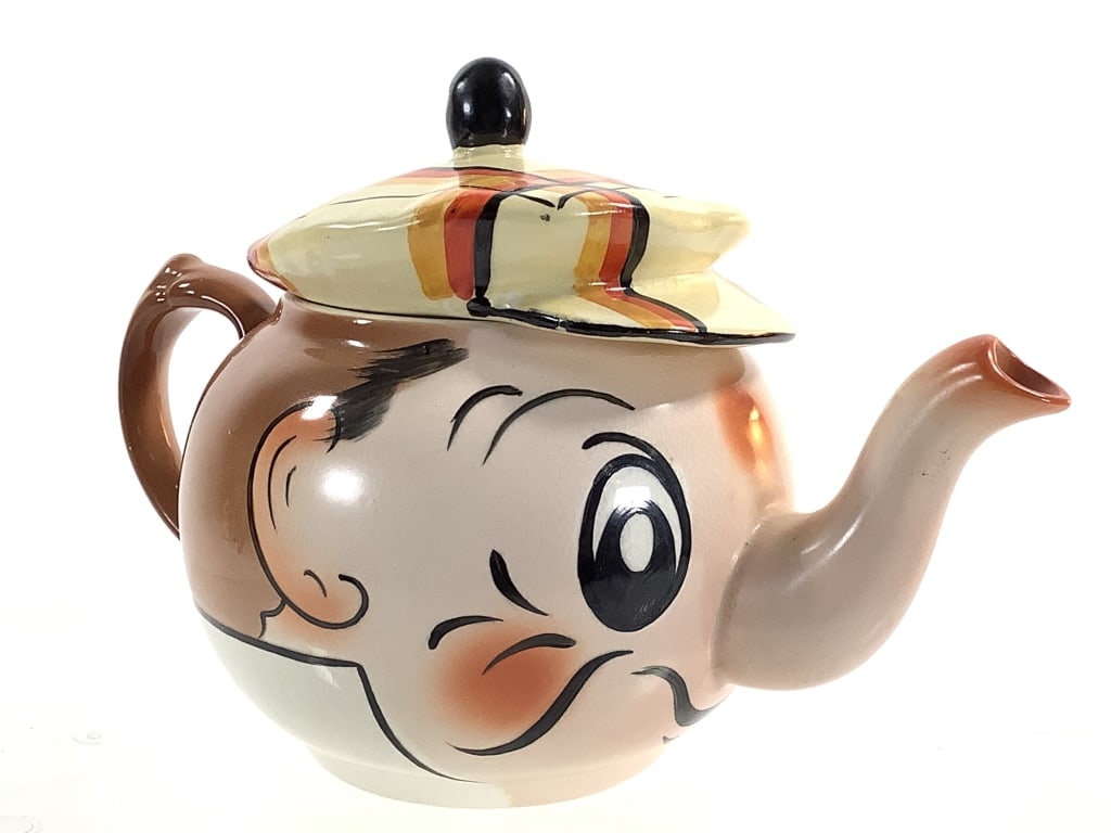 Wade Ceramic Scottie The Golfer Teapot: 8"L c.1953-5 character / novelty teapot with orange, gold and black tartan cap lid. Crazing, otherwise very good overall condition. Hand painted with gold stamp mark on bottom. Provenance: Collection 