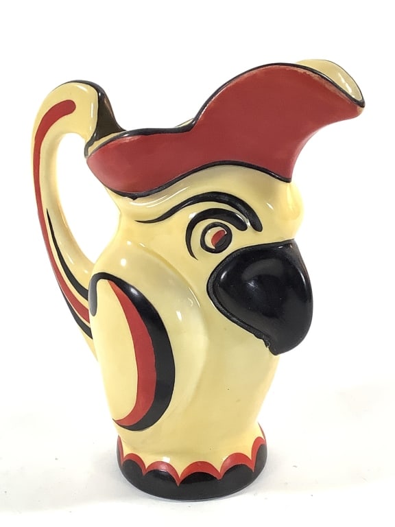 1930s Ditmar Urbach Czech Pottery Parrot Pitcher: 9 1/4"H. Yellow body with black and red hand painted details. Impressed model number on bottom, no other marks. In making split in bottom of the pitcher. Provenance: Collection of William and Diane It