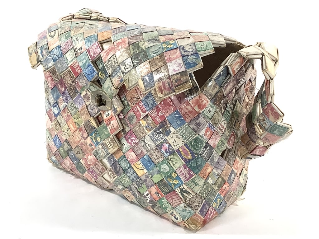 Stamp Craft Folk Art Purse Multiple Countries: 10 1/2" x 5" x 8 1/2"H without strap. Woven cancelled stamps, white interior. Provenance: Collection of William and Diane Itter.