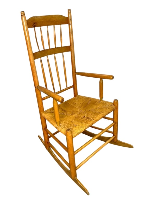 Antique Spindle Back Country Rocking Chair: 20"W x 15"D x 42"H. Mortised and pegged, blade runners, woven rush seat (some losses). Provenance: Collection of William and Diane Itter.