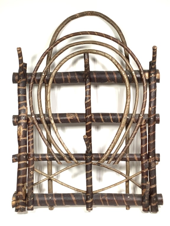 Folk Art Twig Hat Rack: 27"H, 20""W. Bark on twig structure with carved slash pattern. 6 naturally occurring twig branch hooks. Great patina, exposed nail heads. Provenance: Collection of William and Diane Itter.