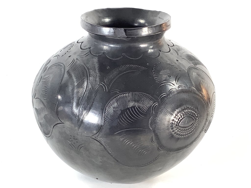 Dona Rosa Barro Negro Pot Mexico: 8"Dia. round bottom black clay pot with traditional incise carved design. Signed Dona Rosa on bottom. Polished black finish. 1/4" nick at rim. Provenance: Collection of William and Diane Itter. Do?a