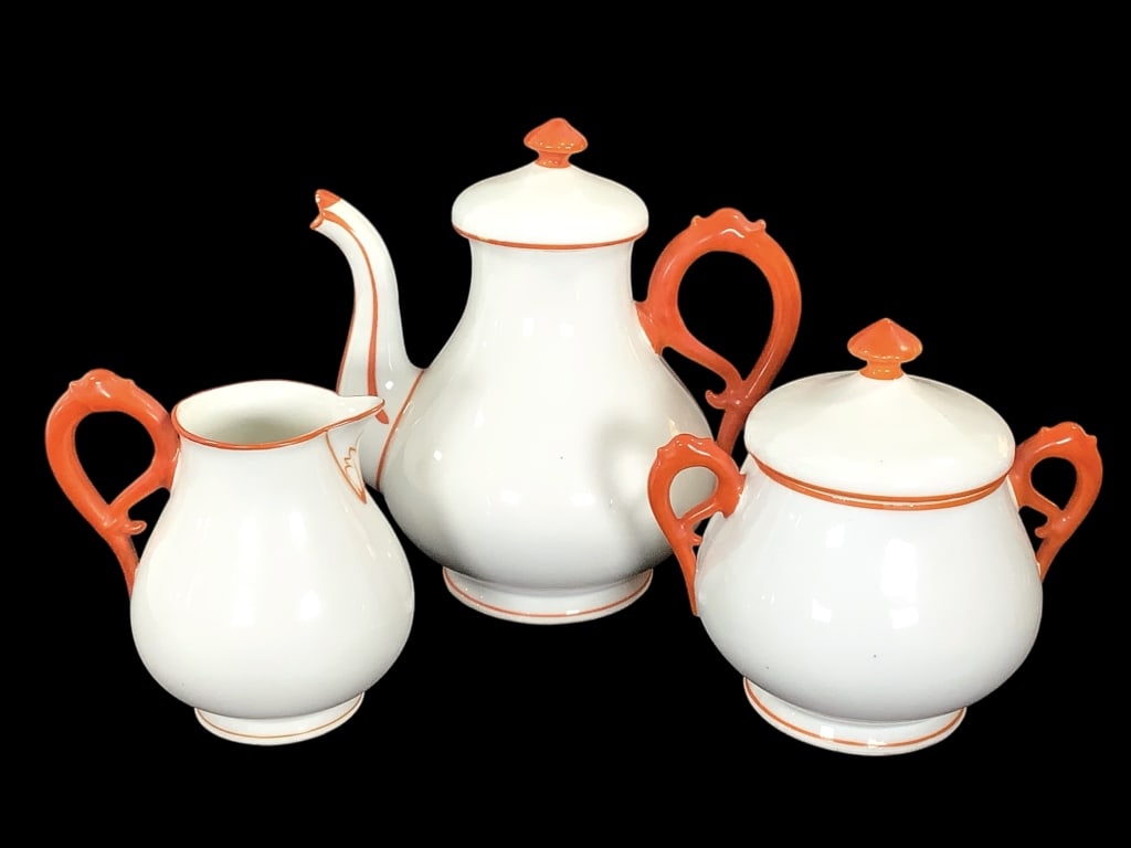 Antique Czech / German Porcelain Coffee Set: 9"H coffee pot, 6 3/4"H sugar bowl with cover, open milk pitcher. Porcelain, white glaze with hand painted orange details. V. G. 146. 12 t impress mark with incised W below on all three pieces.