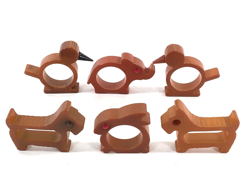 6 Bakelite Animal Form Napkin Rings: Longest (dogs) is 2 3/4". 2 birds, 2 Scottie dogs, elephant and bunny. Provenance: Collection of William and Diane Itter.