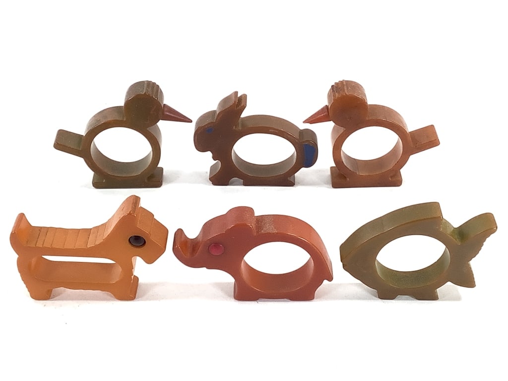 6 Bakelite Animal Napkin Rings: Longest is 2 3/4". Scottie dog and elephant with 'eyes', bunny with blue painted decoration, 2 birds with cone beaks, green fish. Provenance: Collection of William and Diane Itter.