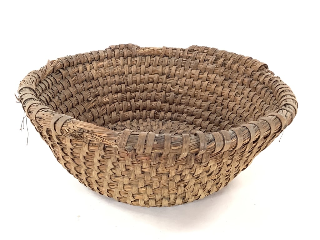 Handwoven River Cane Twill-Plaited Basket: 11"W x 4"D. Shows fraying and minor breakage / splitting along rim consistent with age and use. Provenance: Collection of William and Diane Itter.