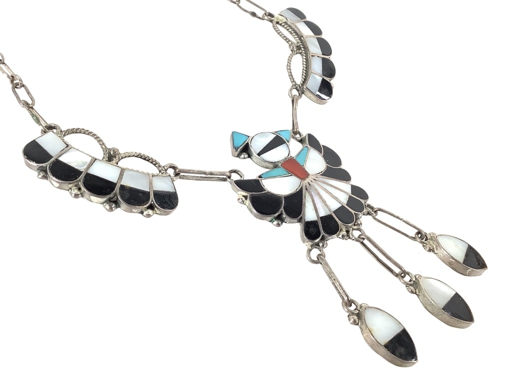 Zuni Artist Signed Sterling Turq+ Inlay Necklace: 16.4 grams total weight. 15" L Thunderbird necklace includes turquoise, coral, jet, and Mother of Pearl. Patina shows expected wear.
