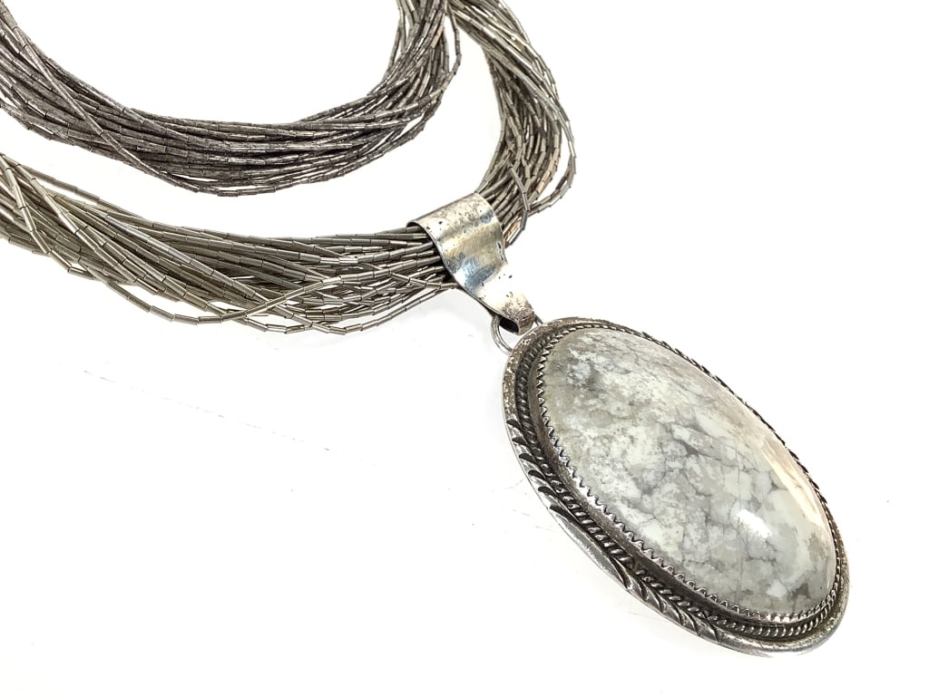 White Buffalo Turquoise & Sterling Necklace 59gTW: 24"L. HL artist's mark, sterling mark on fitting. Stone is secure w/ slight cracks. Liquid silver strands are intact w/ no kinks.