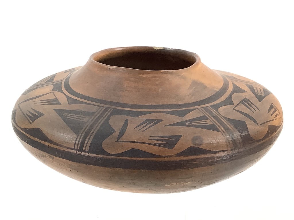 Hopi Pueblo Geometric Pottery Jar: 9 1/2"L x 4 1/2"H. Chipping around rim. Minor cracking along bottom. Overall surface wear consistent with age and use. Structurally intact. Provenance: Collection of William and Diane Itter.
