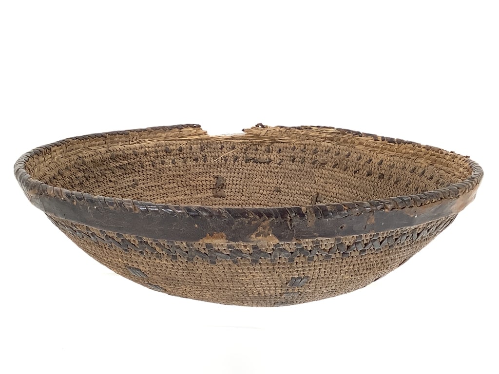 Lg Coiled Basket Bowl w/ Leather Wrapped Rim: 12 1/2"W x 3 3/4"H. 5" Section of rim is heavily damaged, leather wrapping is deteriorating in several areas. Minor fraying on interior. Body is structurally intact with little to no fraying on exteri