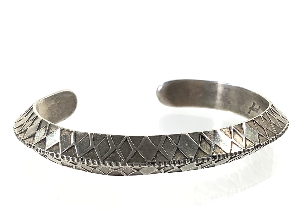 Sterling Bracelet w Embossed Design 33.5gTW: 6.5" L. Marked sterling with artist stamp. Good condition.