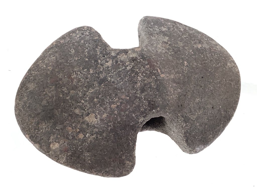 Carved Stone Atlatl Weight: 4"L x 2 1/2"W. From the collection of IU Emeritus Professor John Johnson. Please Note: The artifacts in this auction have not been professionally authenticated. Items may include reproductions,