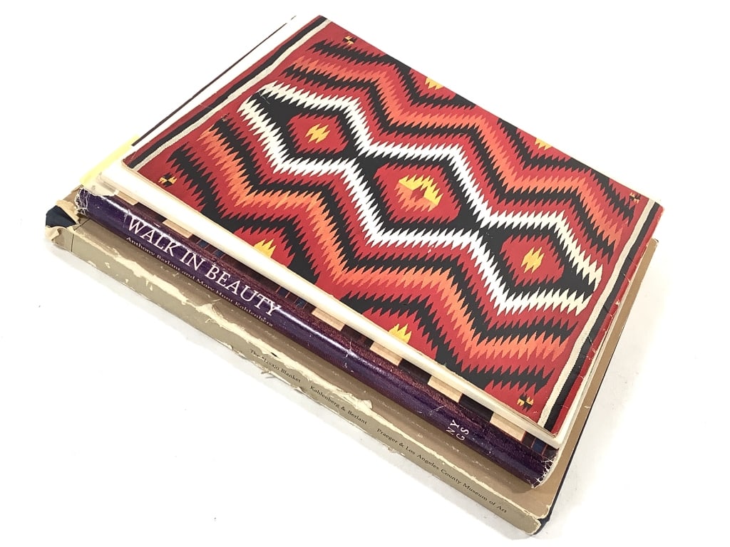 Navajo Blanket Weaving Books: 4 total; 2 paperback and 2 hardback. Paper sleeves show heavy wear, creasing, and tears. Otherwise books in good used condition.