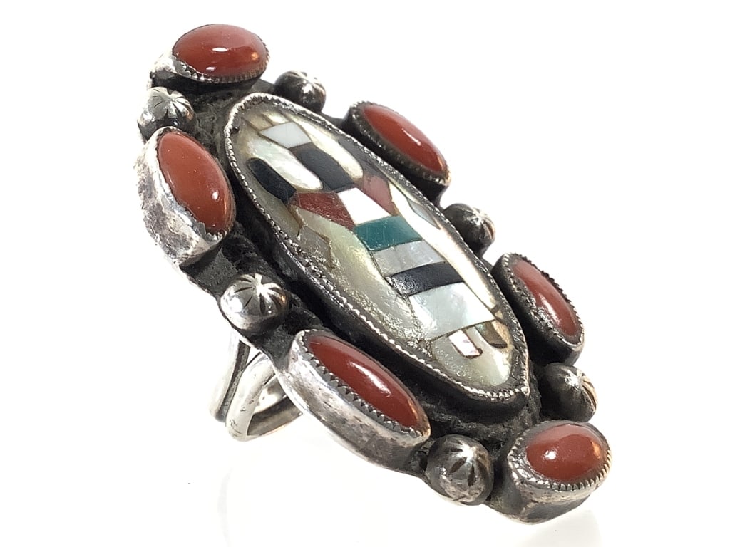 Zuni Olla Woman Sterling & Coral Ring 15.9g TW: Sz. 7. Artist signed. 1 3/4" x 1 1/8" face. Good condition; age related patina.
