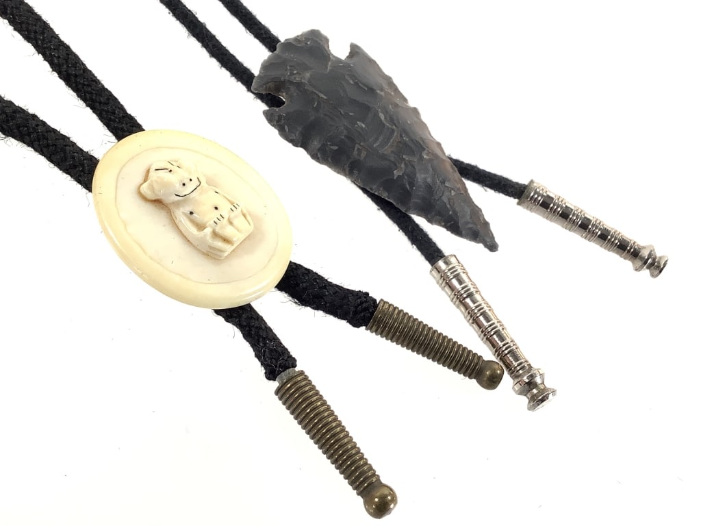 2 Bolos Carved Horn & Arrowhead W Cotton Cords: Cords show wear. Carved horn is 1 1/2" H. Arrowhead is 2 1/4" H