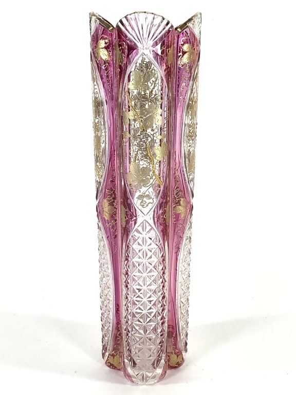 Moser Rubina Optic Rib Vase w Gilt & Enamel: 9"H. Cut and polished glass, flat polished base. Gilt grapevine decorations, rubina iridescent ruby overlay. Small fleabite at top edge fan ridge.