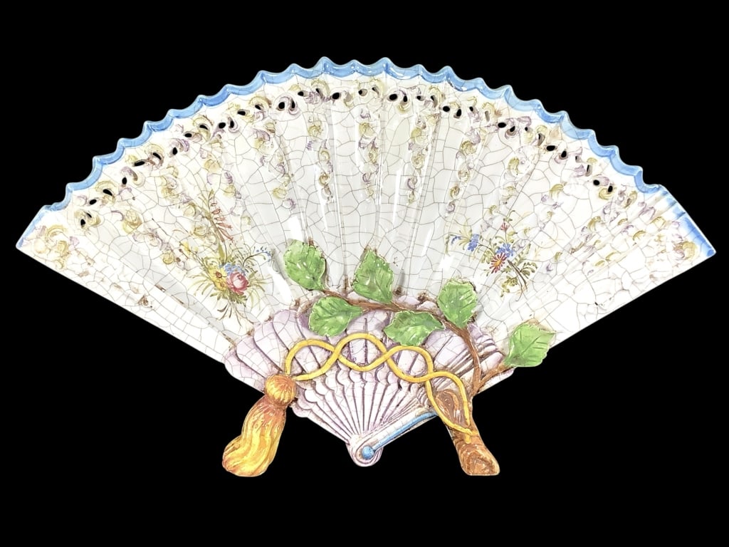 Antica Nove di Bassano Italian Majolica Fan Vase: Charming fan shape Majolica vase with twig and tassel form legs. Stamp mark on back. 10"H, 16 1/4"W. Craquelure glaze, hand painted florals, raised scroll work with piercing below blue top edge.