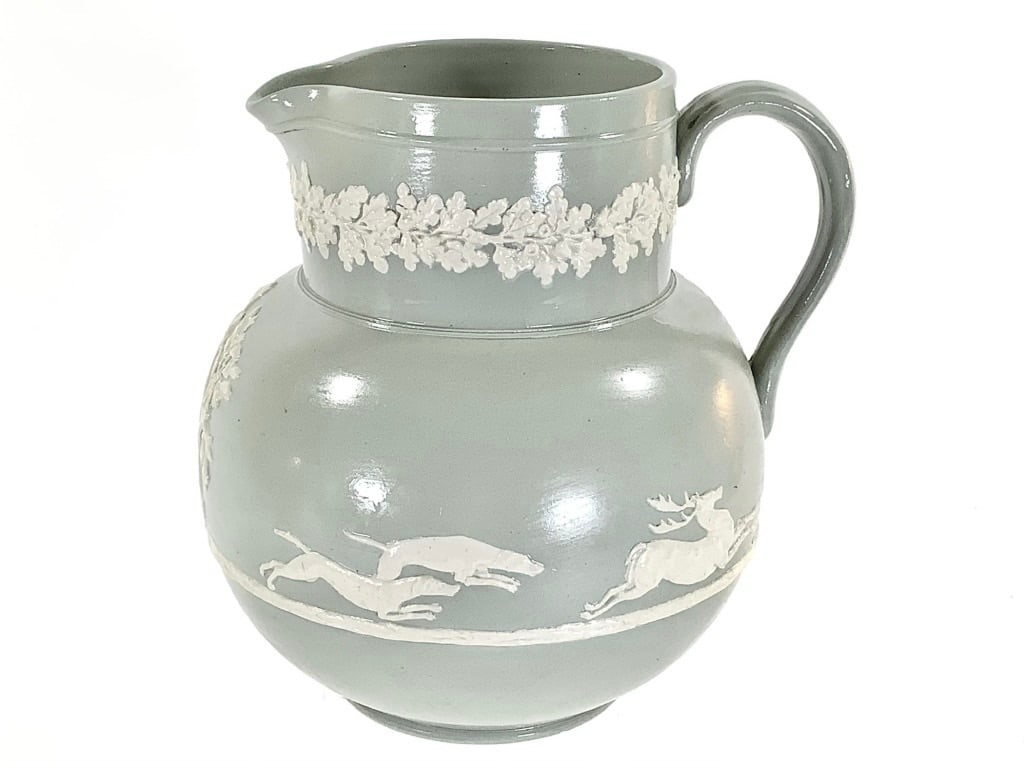 Dudson English Stoneware Hunting Motif Jug: 7"H x 6"W. Circa 1890-1910s. Marked "England Dudson". Minor chip along bottom rim, small cracks on white detailing.