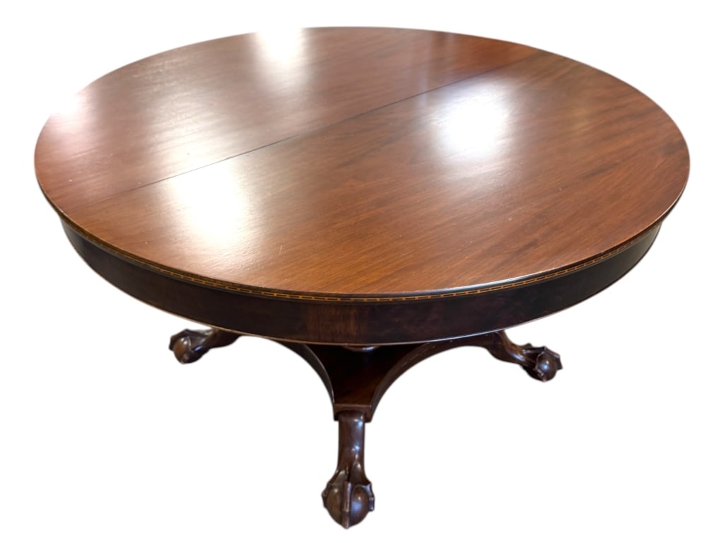 Margolis Large Dining Table w Leaves Carved Feet: 54"Dia closed, 3 - 12"W leaves and center leg support. 90"L x 54"W open. Satinwood and ebony band inlay matching sideboard lot 204f. Split pedestal with claw and ball carved feet.