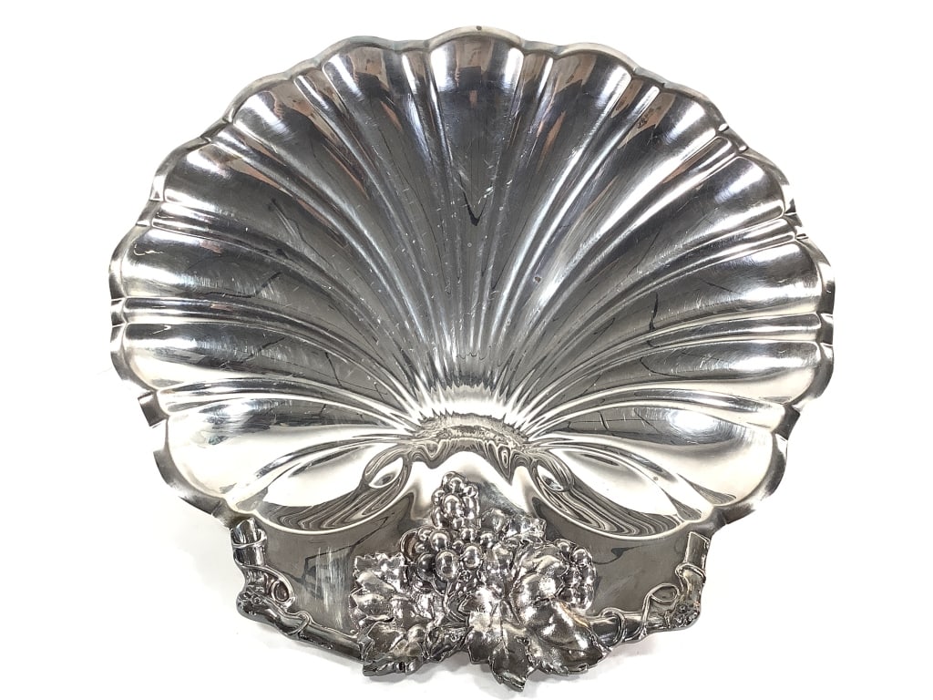 Reed & Barton Silverplate Footed Shell Dish: 11 1/2"W x 2 1/2"H. Marked on bottom. Very small rust spot, as well as minor surface wear. Overall very good condition.