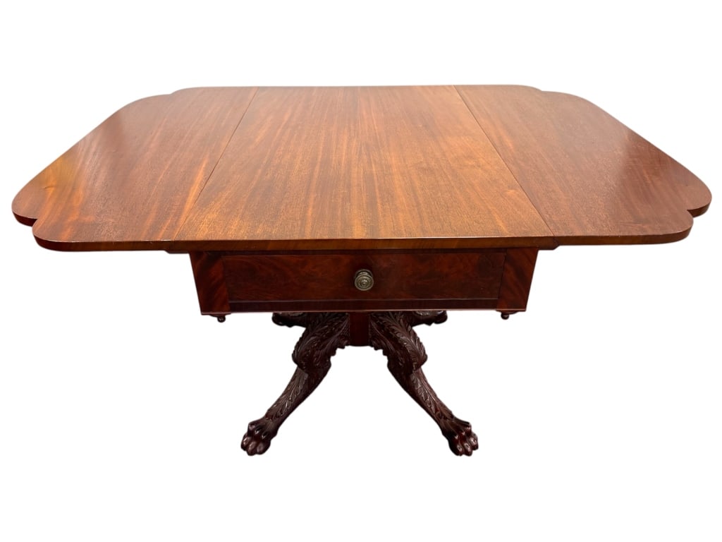 Nathan Margolis Figured Mahogany Drop Leaf Table: 36"L x 22" - 48"W x 28"H table with single drawer with bronze pull. Shaped leaves, carved pedestal and lions paw with acanthus leaf classical revival base. Paper label.