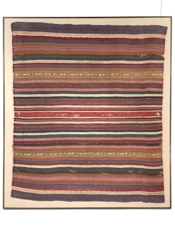 Framed Andean Striped Textile Fragment: Frame 30" x 34", textile 27" x 31". Exact origin unknown, piece lacks the center seam often found on a Manta or Lliclla. Holes dotted throughout, specifically along middle red stripe and along left ed