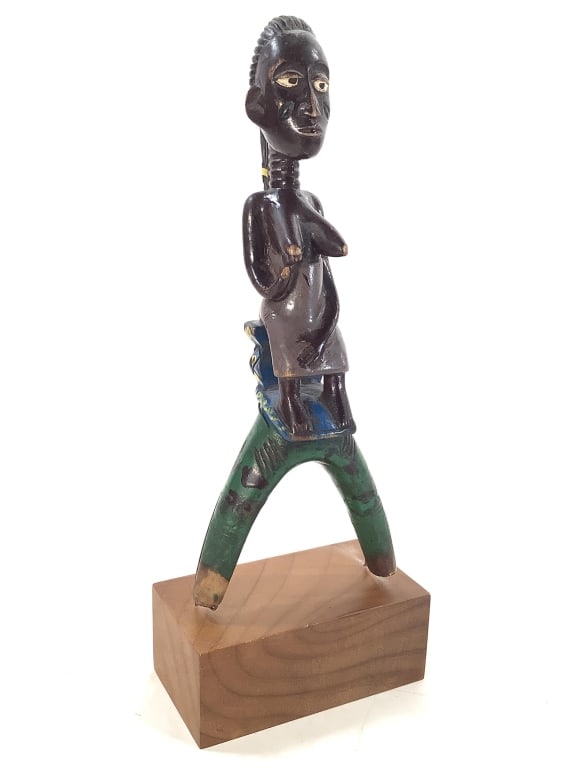 Baule Slingshot Carved Wood Figure Ivory Coast: 9 1/4"H including stand. Painted carved female figure slingshot. Provenance: Collection of William and Diane Itter. Please see photos for condition and details.