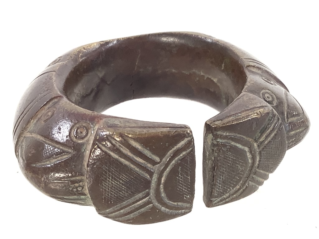 West African Manilla Bronze Currency Bracelet: 3 1/2" x 3 1/8". Provenance: Collection of William and Diane Itter. Please see photos for condition and details.