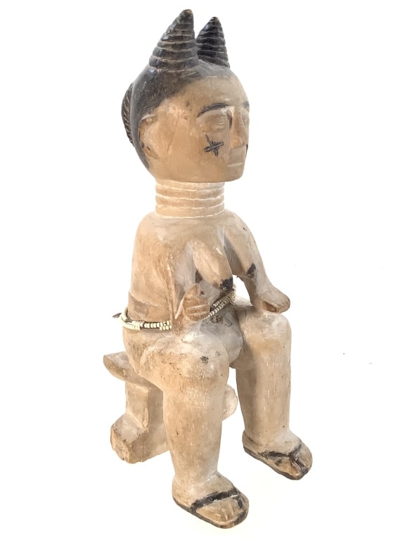 Ewe Seated Wooden Female Figure NIgerian: 11"H. Carved wood female figure with painted pigments details and beads. Chip on right hand, holes at bottom from prior mounting. Provenance: Collection of William and Diane Itter. Please see photos