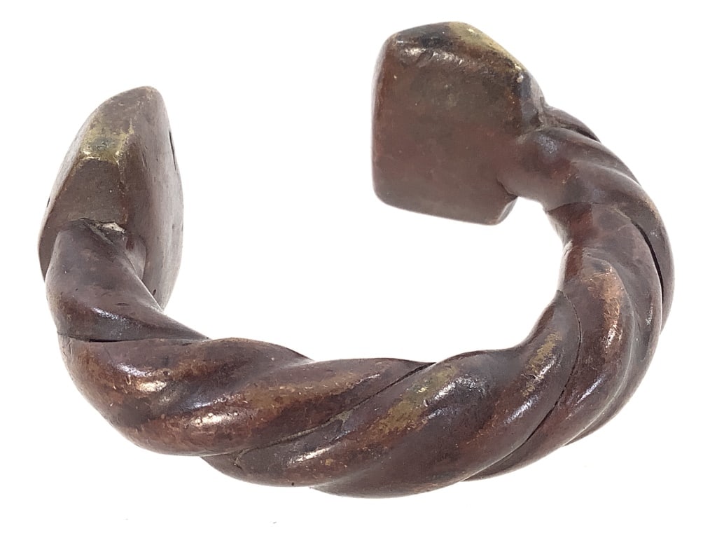 West African Twisted Currency Bracelet: 3 1/2"Dia. Bronze alloy. Provenance: Collection of William and Diane Itter. Please see photos for condition and details.