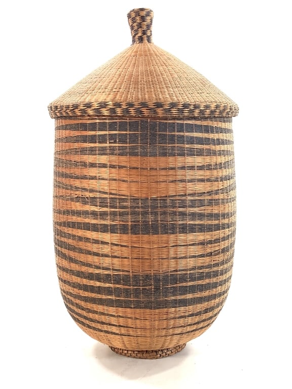 Tutsi Agaseke Lidded Basket Rwanda: 12 3/4"H. Densely woven basket with conical lid of natural fibers with a geometric design in black pigment. Provenance: Collection of William and Diane Itter. Please see photos for condition and detai