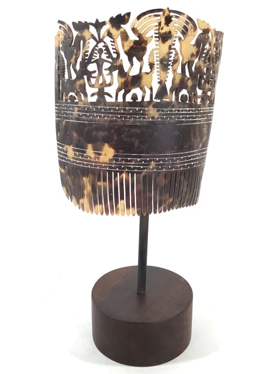 Indonesian Hai Kara Jangga Ceremonial Hair Comb: 5 1/2"W x 6"H. Hand carved from mottled sea turtle shell. Come with stand with wood base with metal bracket.. Provenance: Collection of William and Diane Itter. Please see photos for condition and det