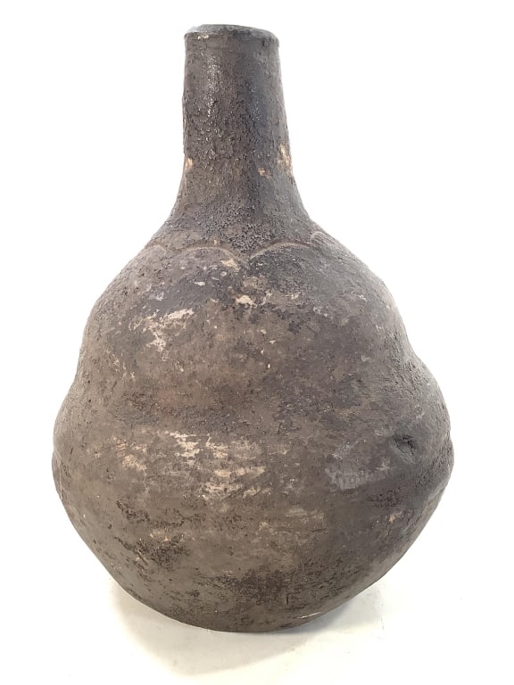 Democratic Republic of Congo Water Bottle: 9 3/4"H x 6 7/8"Dia. Terracotta water pot / bottle with bulbous base and a elongated neck with incised design at the base of the spout. Minor surface wear at top spout, Please note: Some pots may