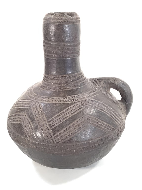 Incised Pitcher w Handle DRC: 8 1/2"H 7 1/4"Dia. Chips at top lip, Nice brown pigment surface/ patina. Provenance: Collection of William and Diane Itter. Please see photos for condition and details. Please note: Some pots may