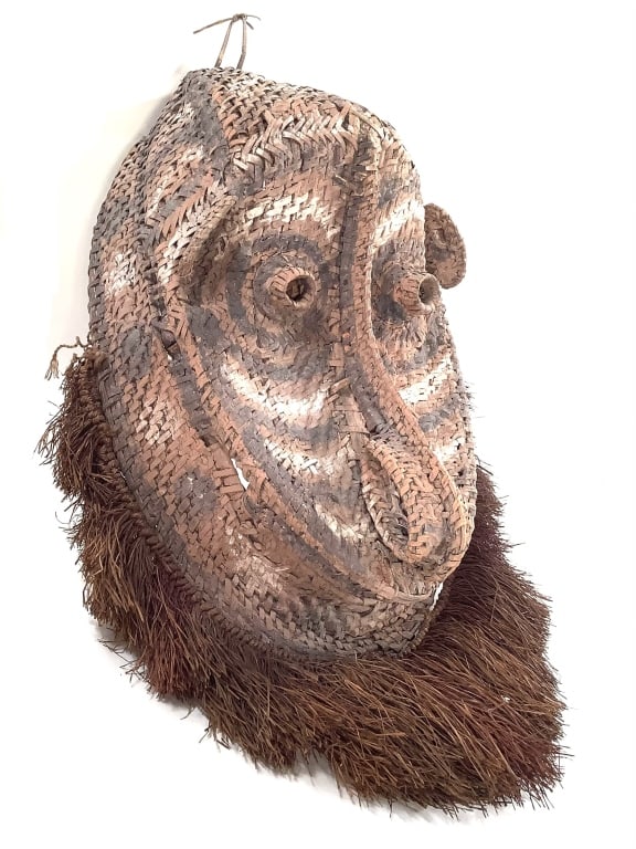 Papua New Guinea Yam Mask w Raffia Fringe: 21"H x 14"W x 6 3/4"D. Provenance: Collection of William and Diane Itter. Please see photos for condition and details.